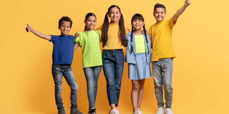 cool-diverse-kids-having-fun-on-yellow-background