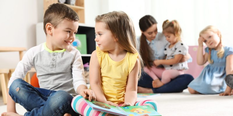 cute-little-children-reading-book-together-indoors